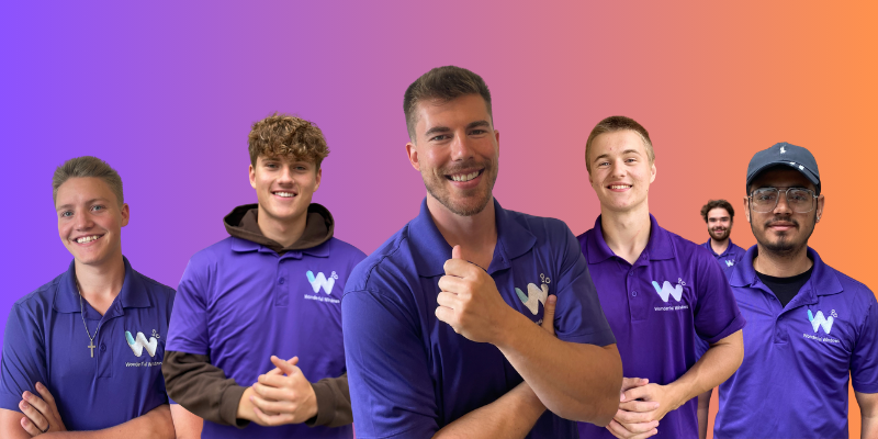 The Wonderful Windows crew, seven team members in purple company polo shirts