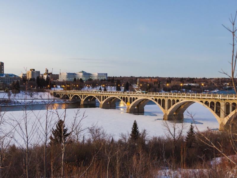 The Broadway Bridge over the frozen South Saskatchewan River in Saskatoon, seen through the window